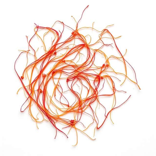 High-quality Iranian saffron threads (Negin grade) on white background — premium Persian saffron